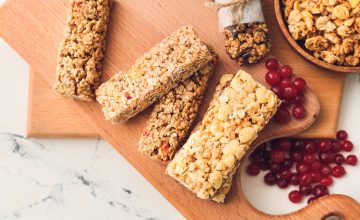 Granola bars and berries on a wooden board