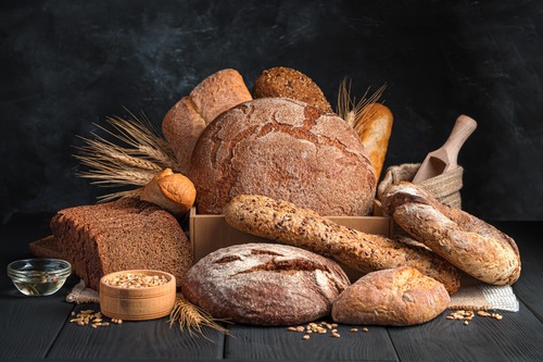 Healthy bread overfilling a bread basket with wheat and flour