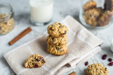 Breakfast biscuits containing soy lecithin with cranberries and a glass with milk