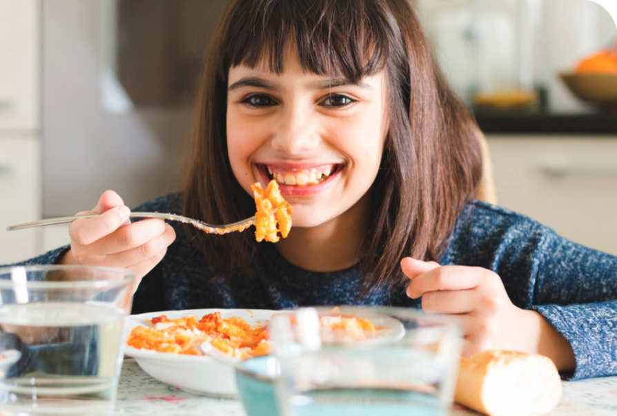 Girl eating pasta