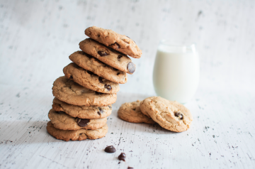 tower of chocolate chip cookies and glass of milk
