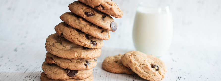 tower of chocolate chip cookies and glass of milk