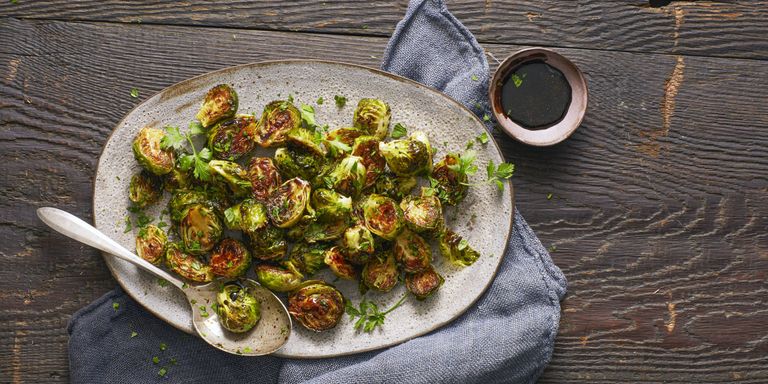 roasted brussel sprouts on serving dish with sauce