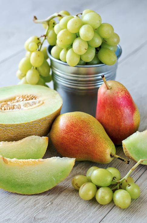 pile of fruit grapes melon pears