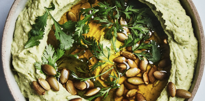 avocado hummus with nuts on top