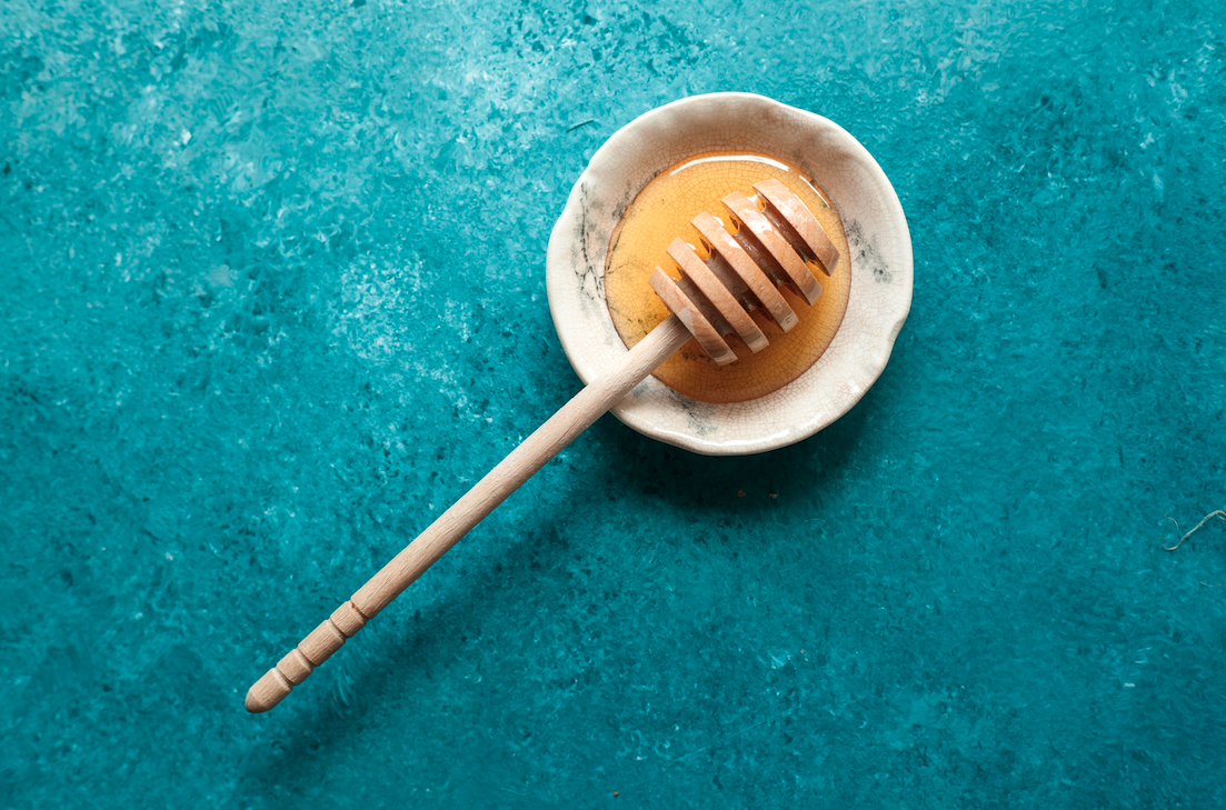 honey wand in bowl of honey