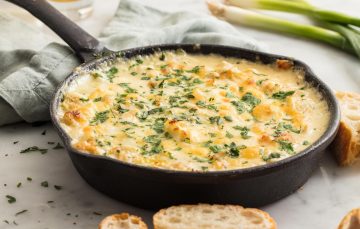 crab artichoke dip in cast iron skillet