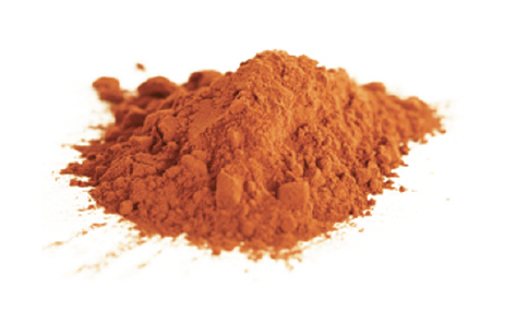 pile of light brown cocoa powder on a white background