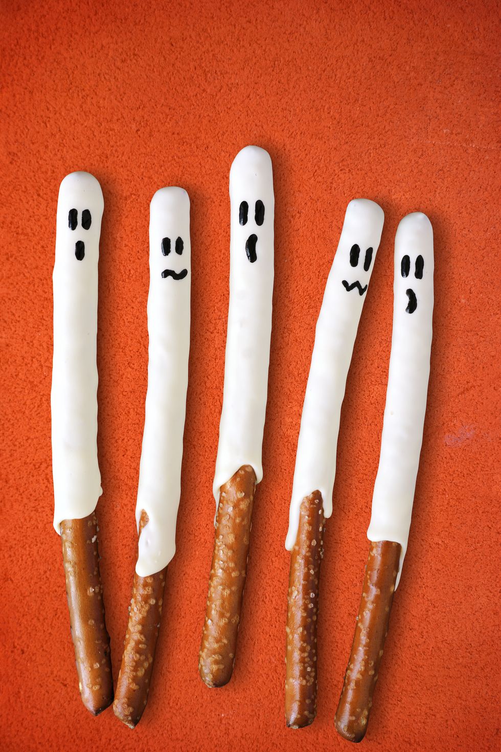 pretzel sticks decorated as white ghosts for halloween
