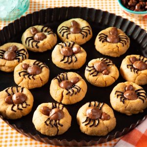 Halloween spider cookies on a black plate