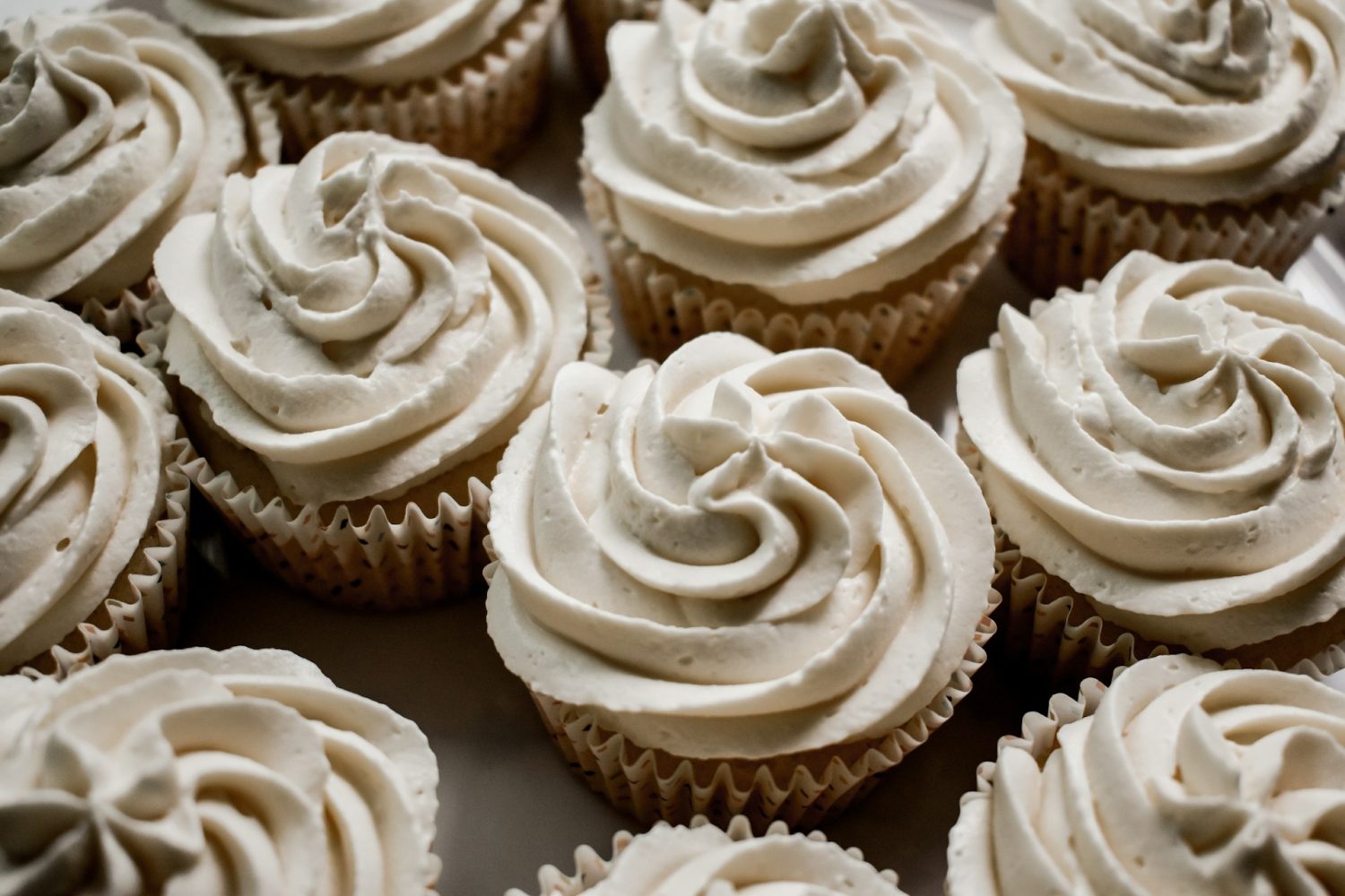 Vanilla cupcakes with vanilla bean icing shot in a close-up