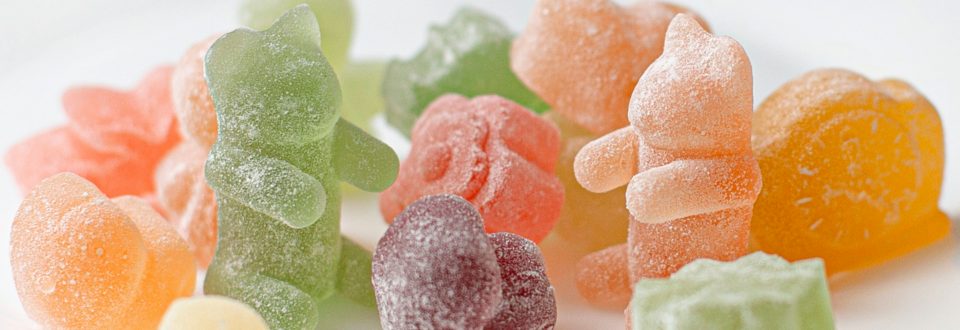 Assorted colorful gummy candies representing natural food coloring applications.