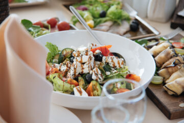 Ready-to-eat Greek salad on a white plate on the table