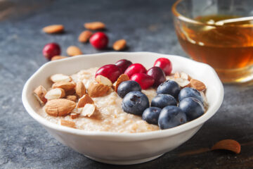 Bowl of oatmeal topped with cranberries and blueberries, illustrating clean nutraceuticals in everyday nutrition