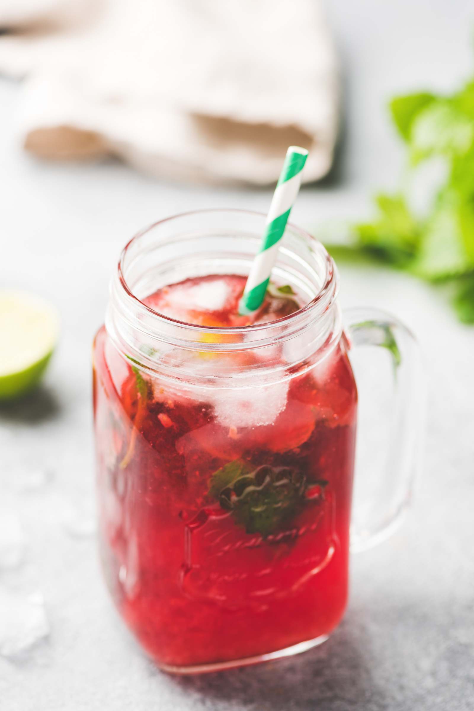 pink beverage in a mason jar with mint