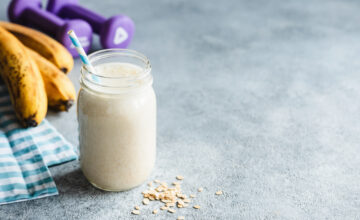 Protein shake with bananas and weights nearby